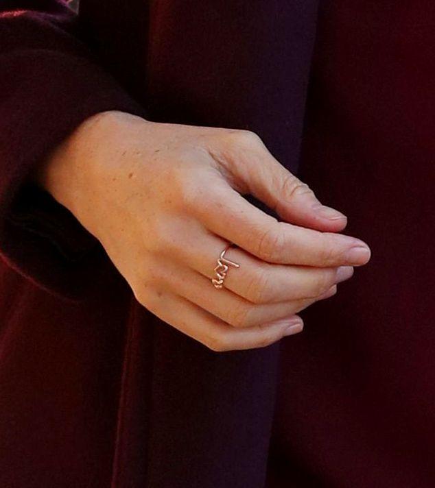 The rose gold ring features a heart in the place of an ‘o’