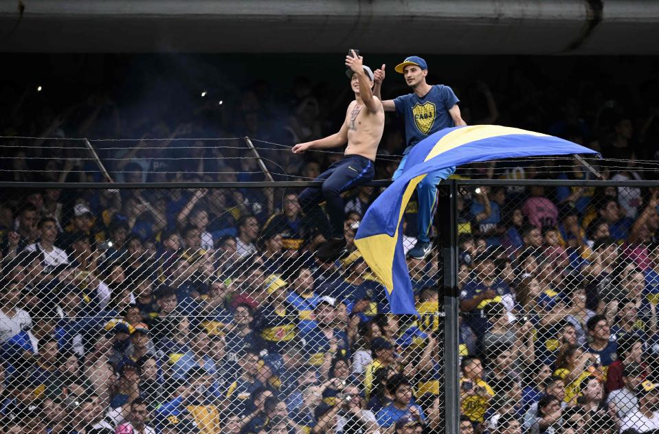 Other supporters scaled wire fences to get a view of the action