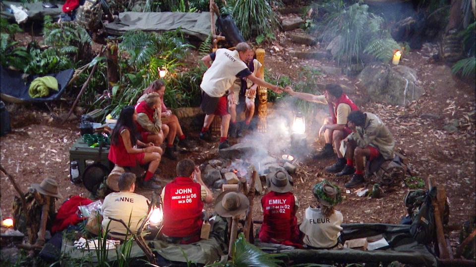  The celebrities gathered round the campfire to receive their packages