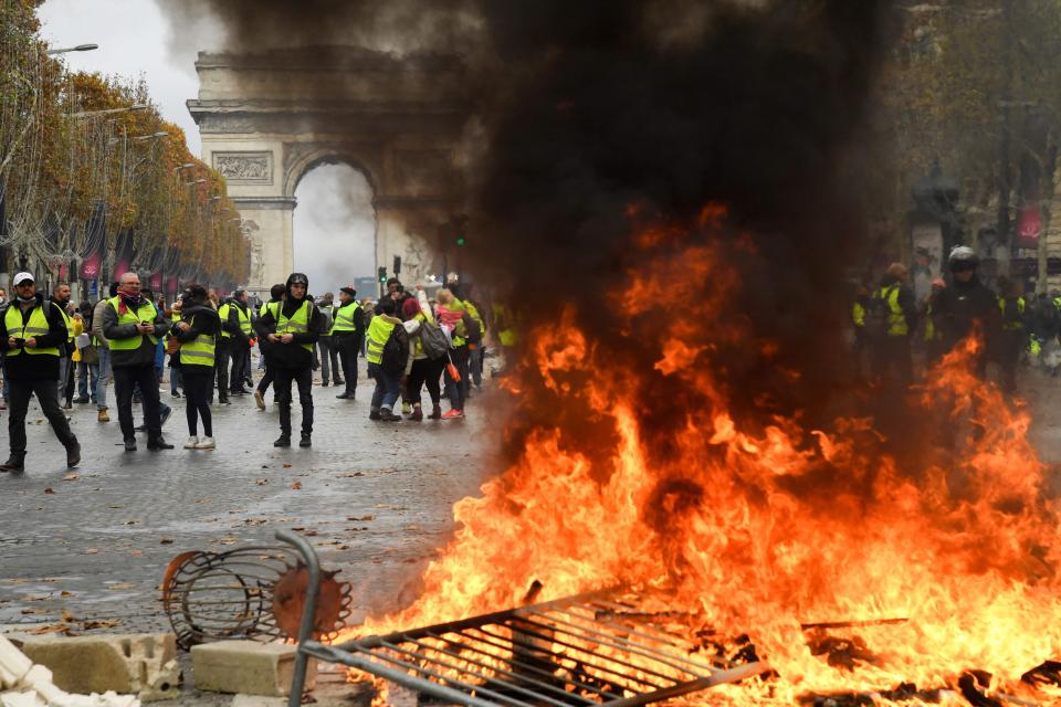  A fire rages as men wearing yellow vests protest against rising fuel prices on the Champs-Elysees