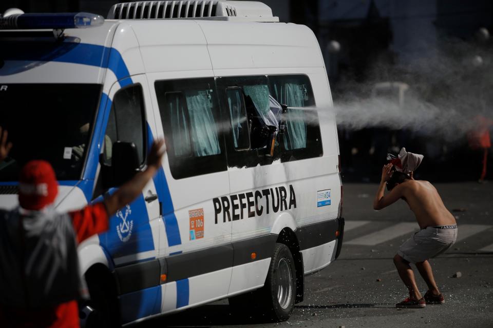 A fan is targeted with pepper spray as he tries to cover himself