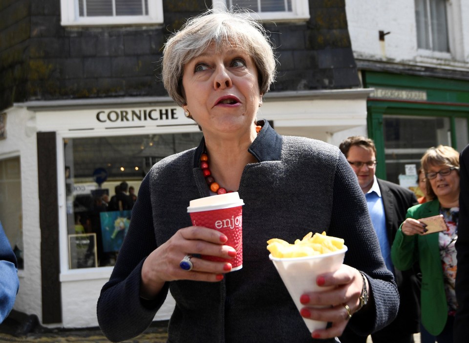 The PM seen eating chips on the stump in Mevagissey, south-west England, for the 2017 elections when she lost her majority