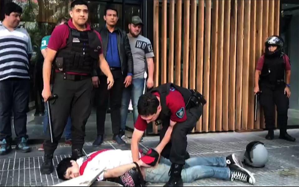 A police offer carries out another arrest on the streets of Buenos Aires