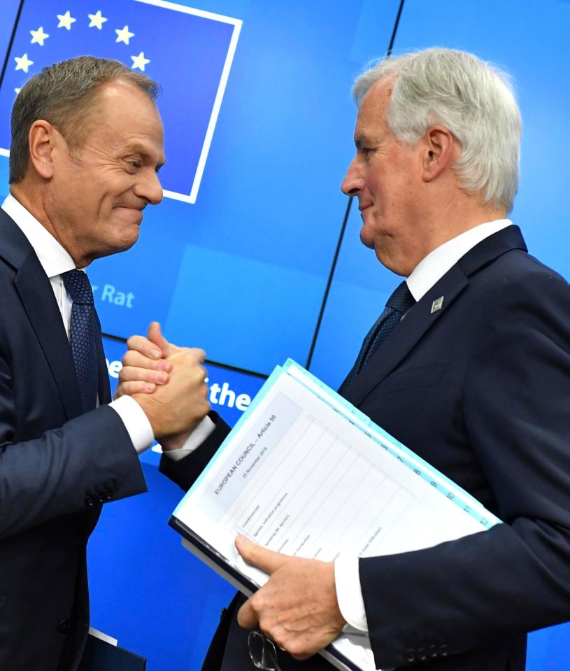 European Council President Donald Tusk, left, shakes hands with European Union chief Brexit negotiator Michel Barnier after striking the deal