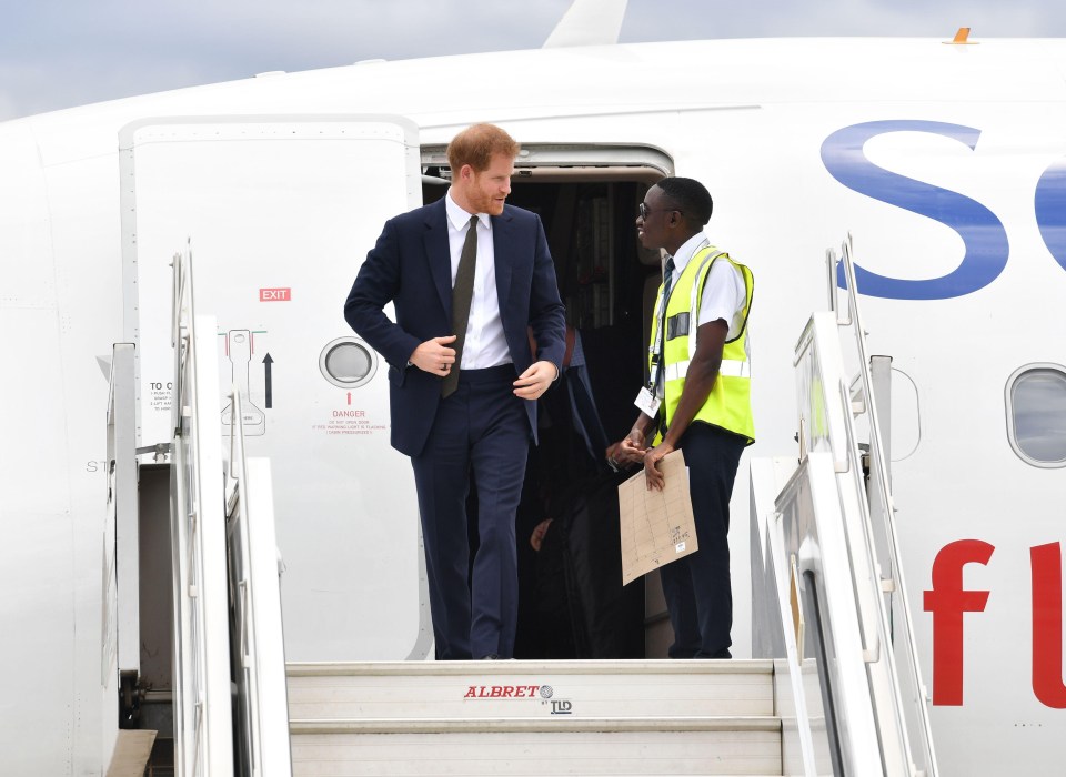 Harry pictured exiting the plane in Lusaka