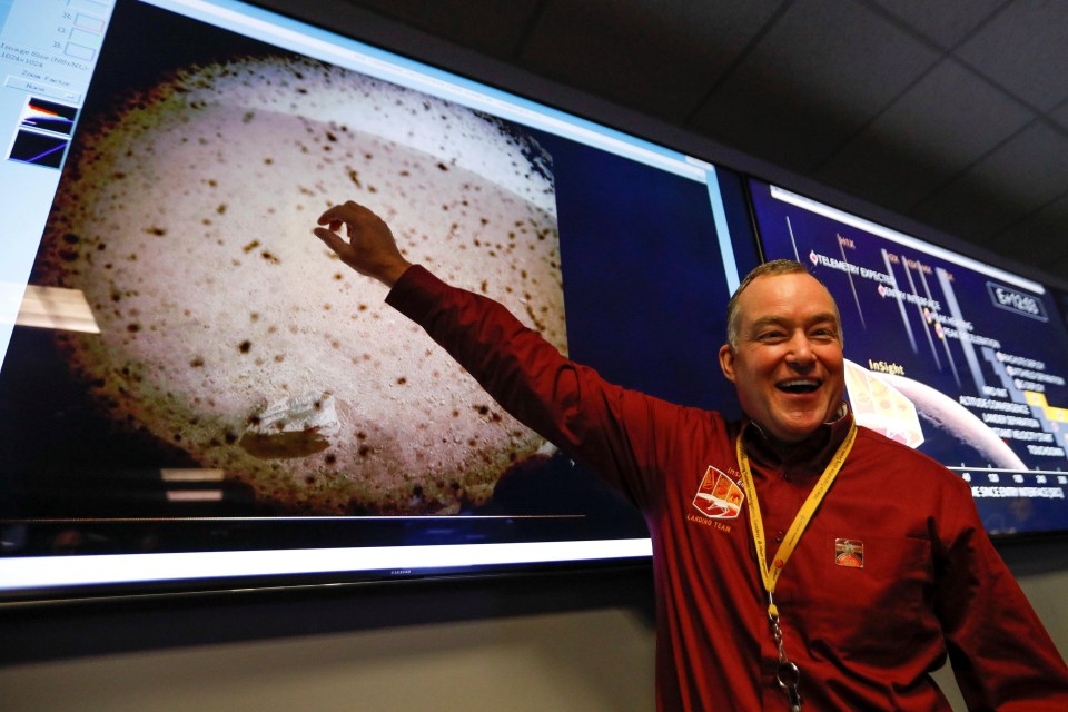 Project manager Tom Hoffman points to the first picture sent back to Earth from Mars by the spaceship InSight at NASA’s Jet Propulsion Laboratory (JPL) in Pasadena, California