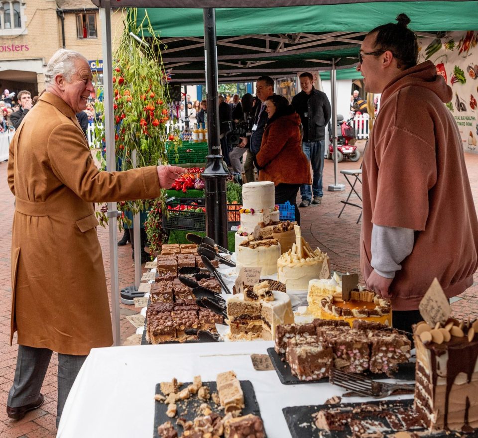  Showing his affection for confection, Charles chats with one of the market stall holders