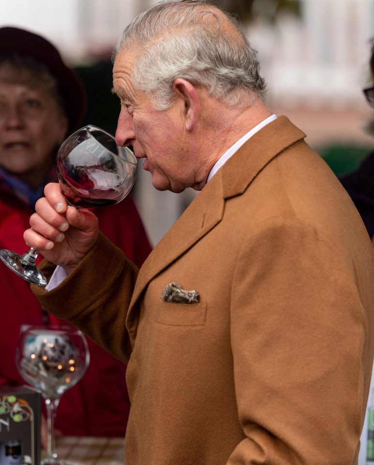  The Prince of Wales enjoys a sip of local wine at the market whilst mingling with market sellers