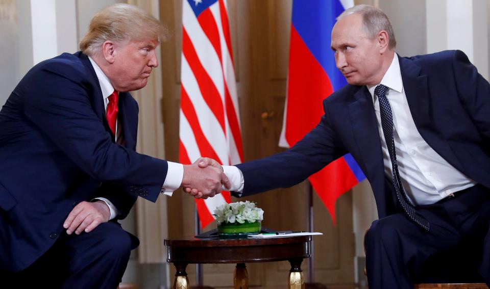  Trump and Putin shake hands at the beginning of a meeting at the Presidential Palace in Helsinki in July