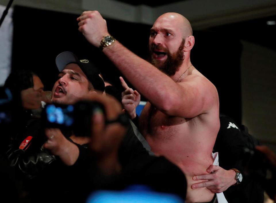  Fury ripped off his shirt as the two men came close to blows in the presser