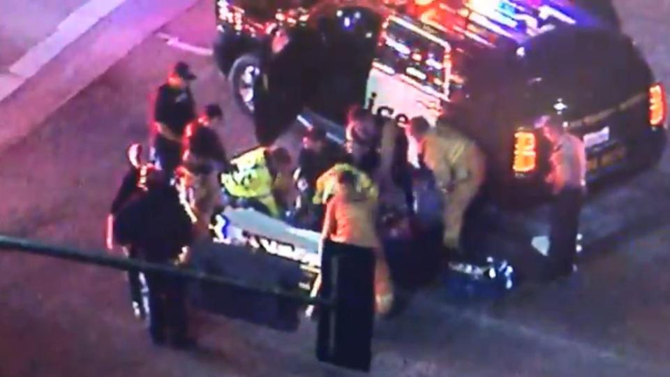  Emergency workers treat an injured victim near the Borderline Bar and Grill