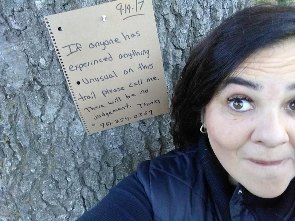  Claudia next to the sign she put up on the trail