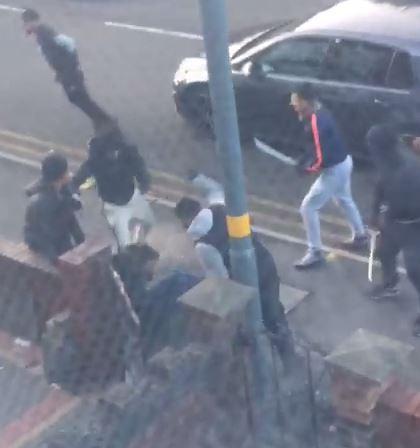  Machete-wielding thugs pounce on a helpless victim beside a busy road in Birmingham