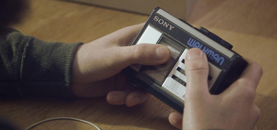  He then inserts the tape into an old school Sony Walkman