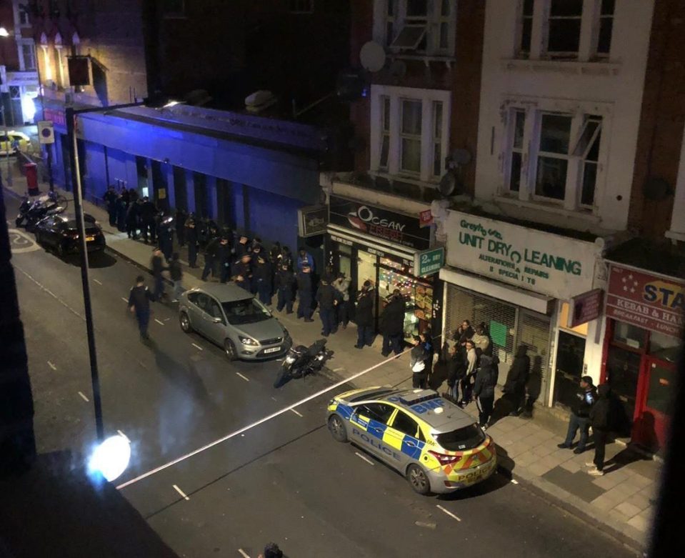  Police line up the suspects outside the scene of the house party on Greyhound Road in Hammersmith