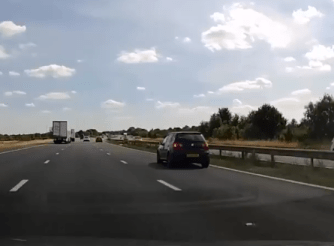 The VW driver brakes to a stop in the right-hand lane of the M1