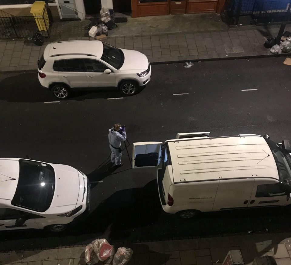  A forensic officer can be seen photographing the scene of a stabbing in Hammersmith in the early hours of Monday morning