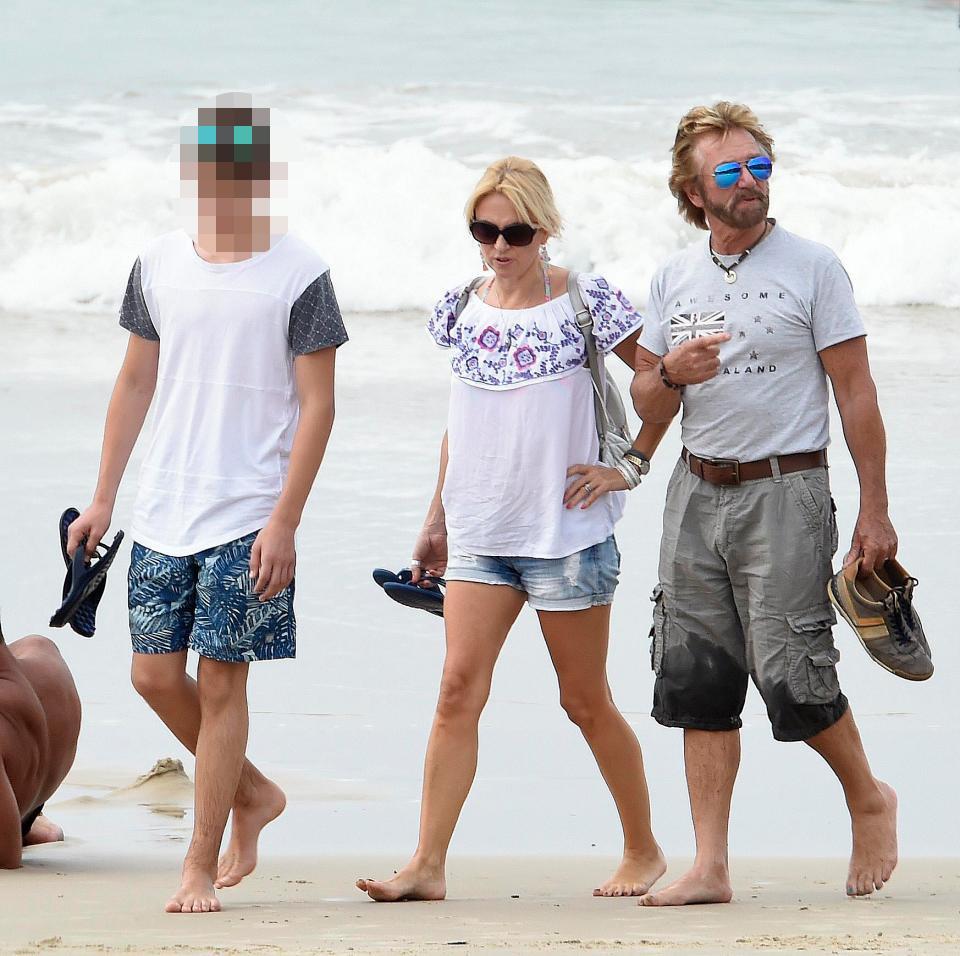  The family took off their shoes to enjoy the beach walk