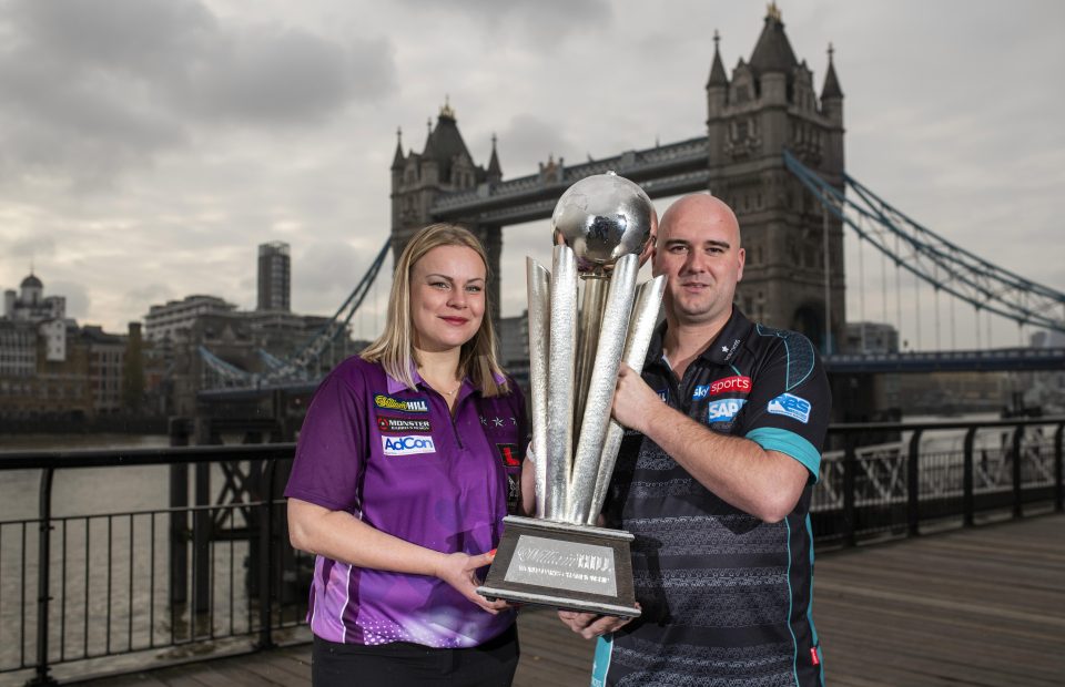  Dobromyslova, 34, poses with the PDC world title next to 2018 champ Rob Cross