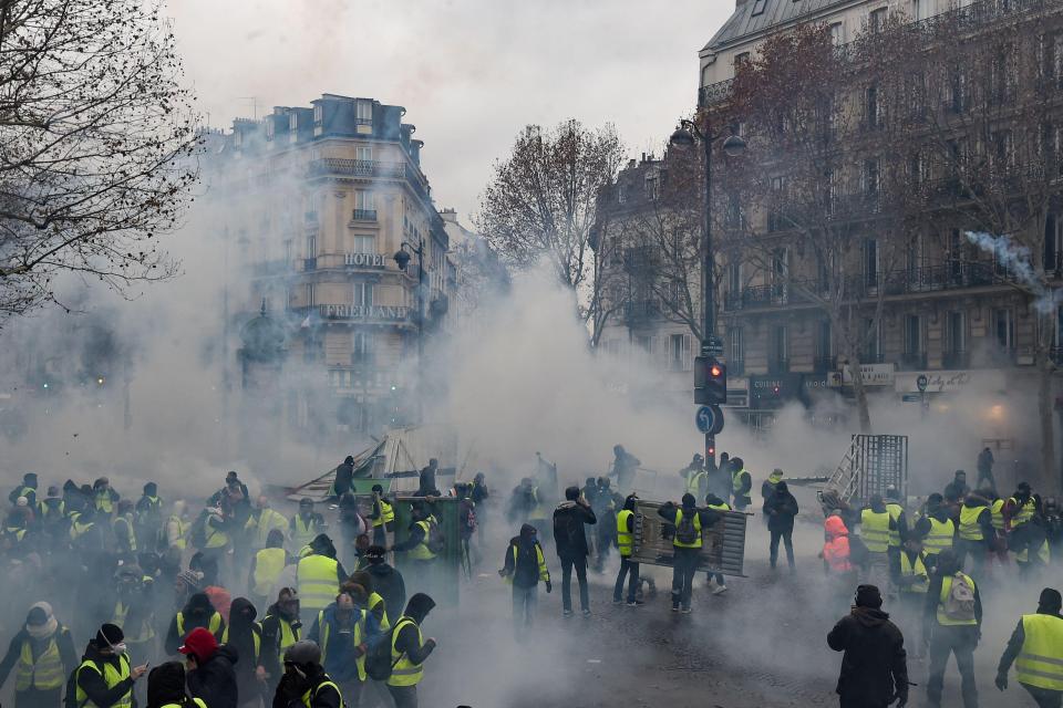  Tear gas is tossed during pitched battles between riot cops and masked thugs in the heart of Paris