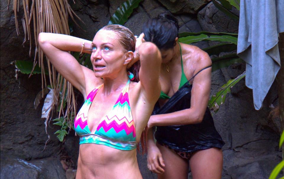  Rita rinsed off her pink hair as she cooled off in the jungle shower