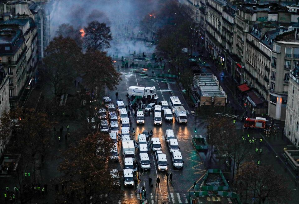  Riot police surround the Arc de Triomphe as violence escalated in the French capital