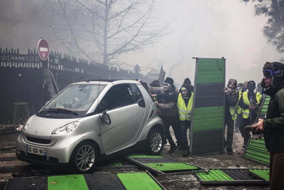  Protesters made makeshift barriers and shields as they charged police lines