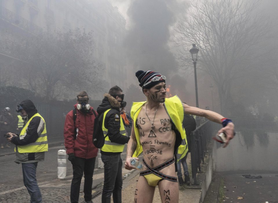  An anarchist protester takes in the scene of destruction in Paris