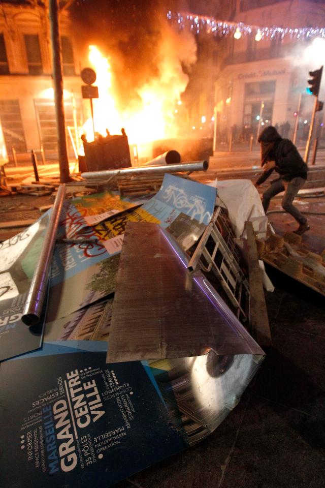  Demonstrators clash with police near burning barricades in Marseille