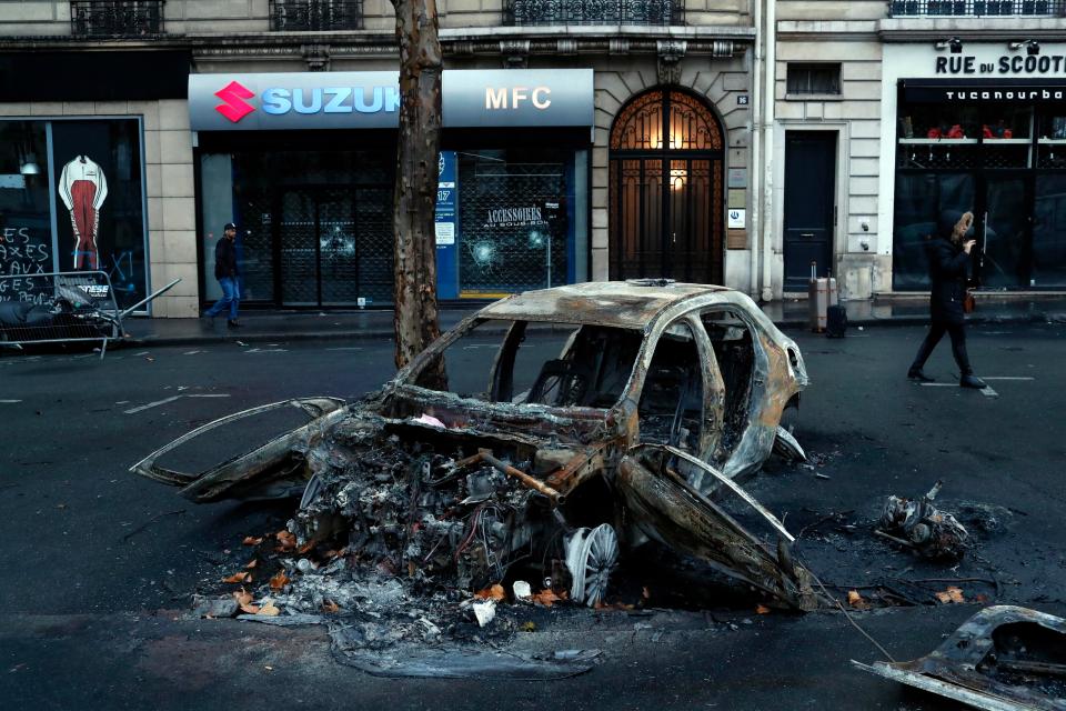  The charred wreckage of a car set alight during the chaotic violence yesterday