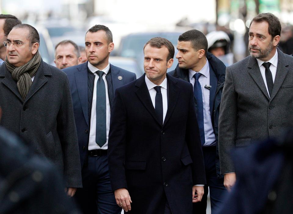  President Macron, centre, assesses the damage caused by rioters in Paris alongside Interior Minister Christophe Castaner, right.