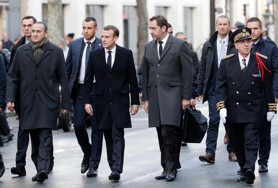  President Macron flanked by ministers and police chiefs survey the scenes of destruction in Paris