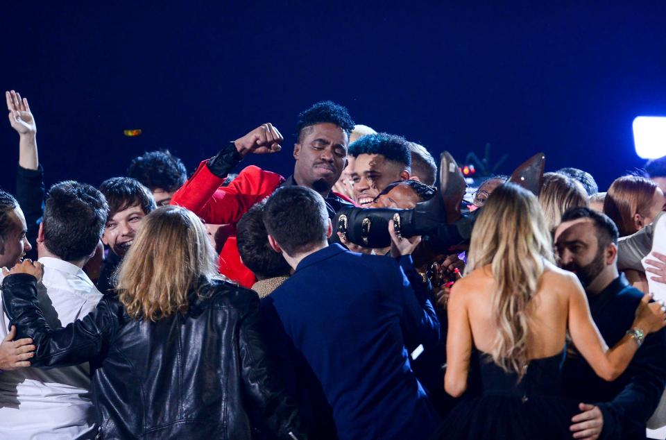  The 24-year-old was grabbed by his former X Factor co-stars as the credits started to roll