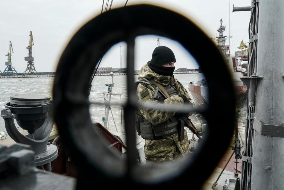 A Ukrainian serviceman stands on board a coast guard ship in the Sea of Azov port of Mariupol