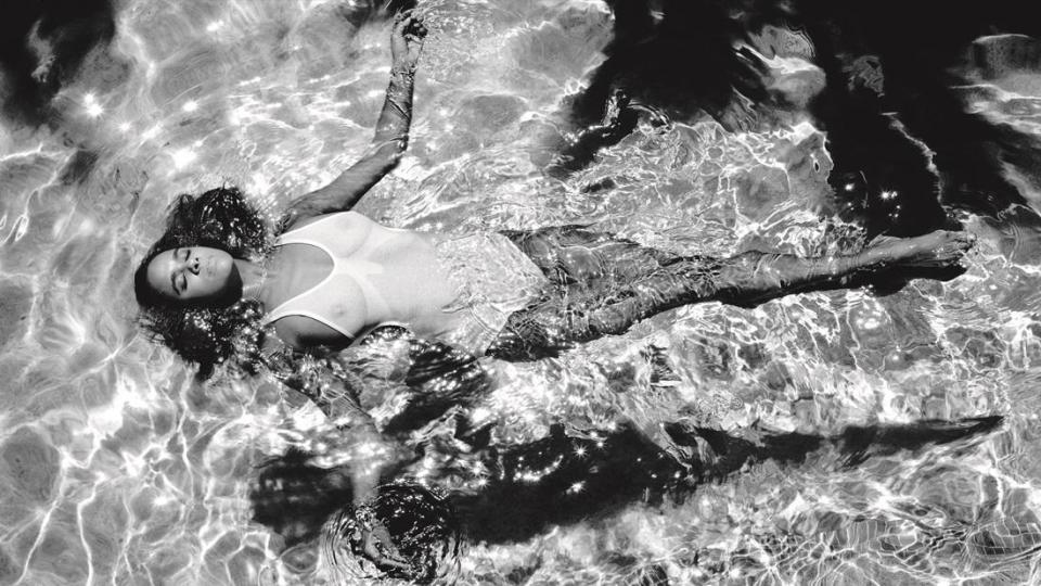  A more relaxed shot sees Misty lying weightless in water while wearing a white swimsuit