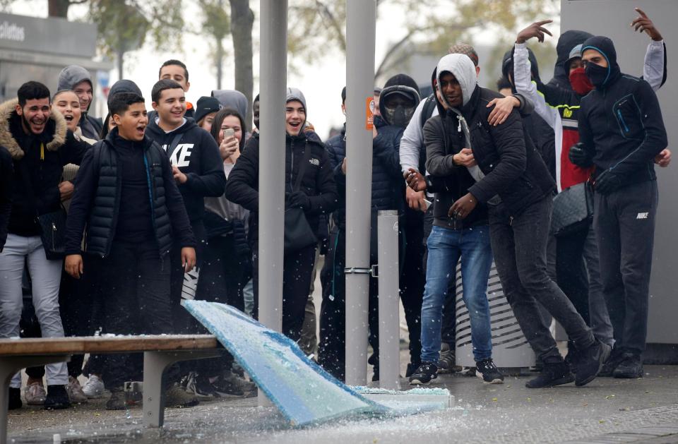  School students watch a tram stop being smashed in Bordeaux