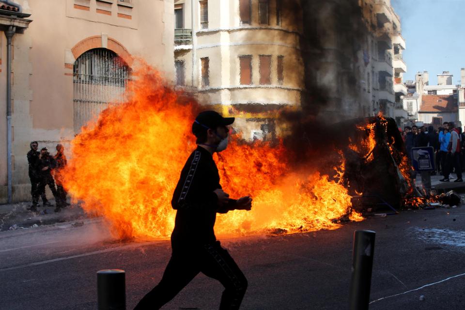  Protesters including high-school students burn plastic bins at an anti-government demo in Marseille