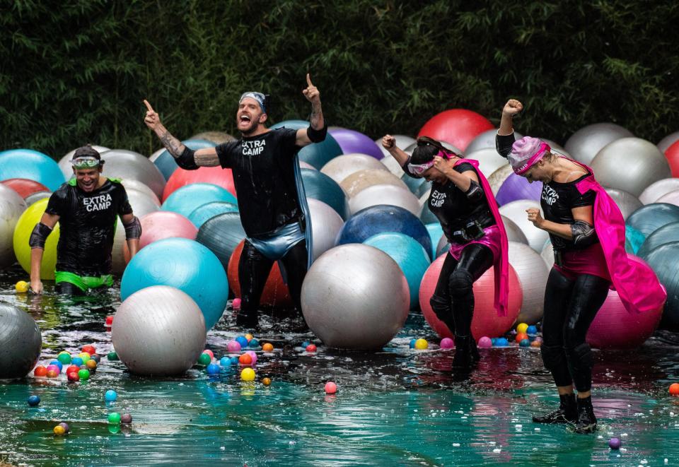 The team celebrate after being battered by dozens of giant plastic balls