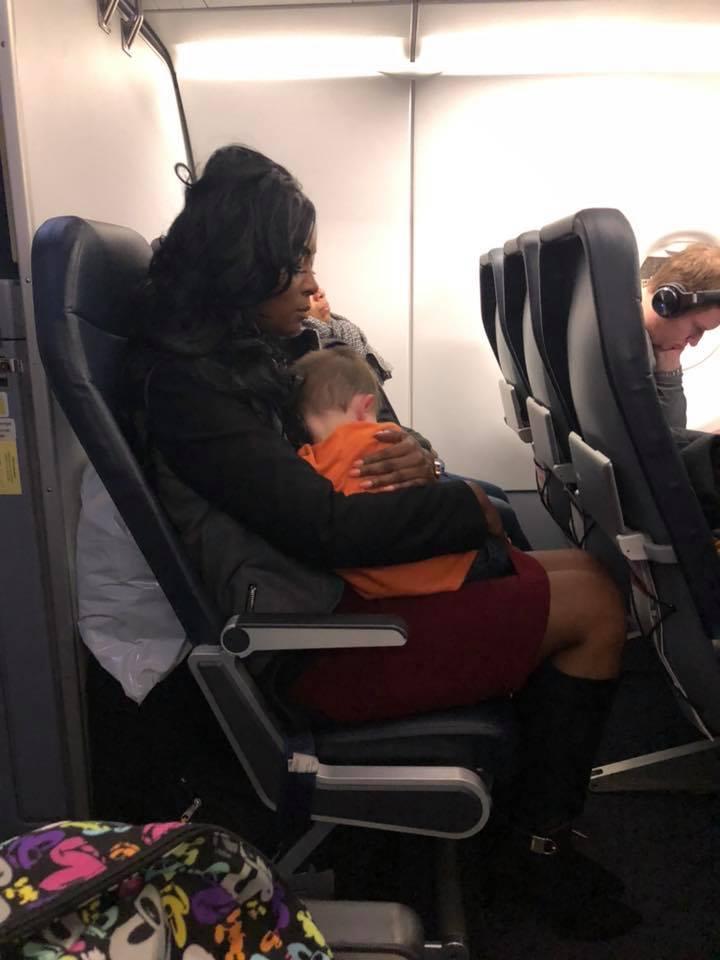  A woman who cuddled a stranger's son during a stressful plane journey has been labelled an 'angel'