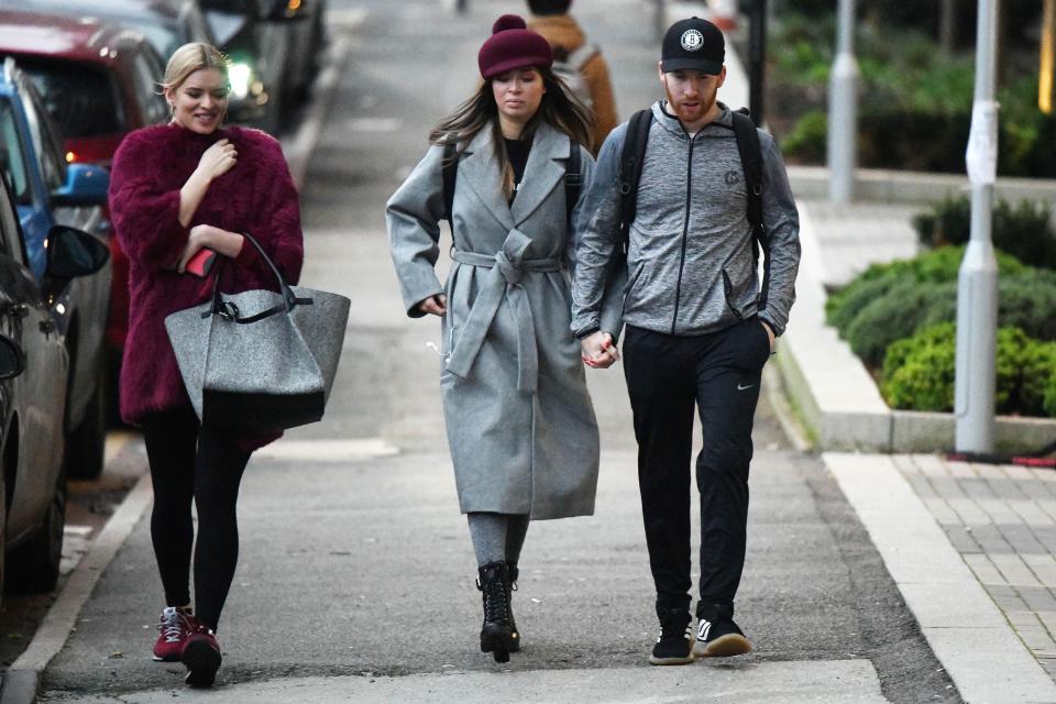  Neil and Katya held hands as they were joined by a pal