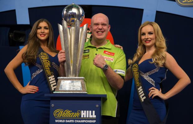 van Gerwen poses with the Sid Waddell trophy after his victory in the PDC World Championship darts final last year