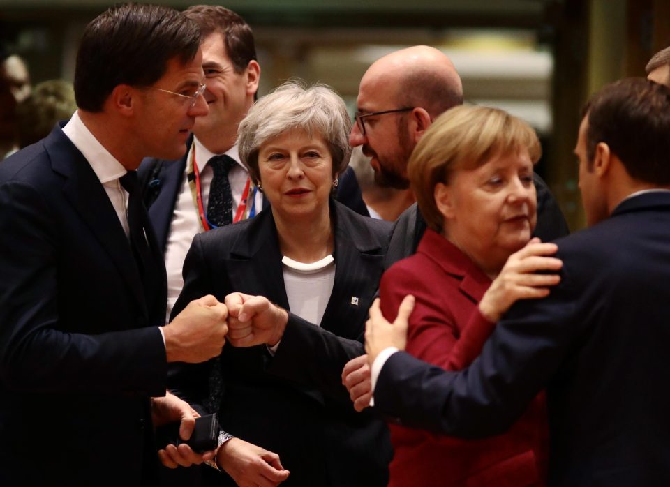  Theresa May is frozen out as Angela Merkel and Emmanuel Macron embrace while the Dutch and Belgian PMs do a fist-bump