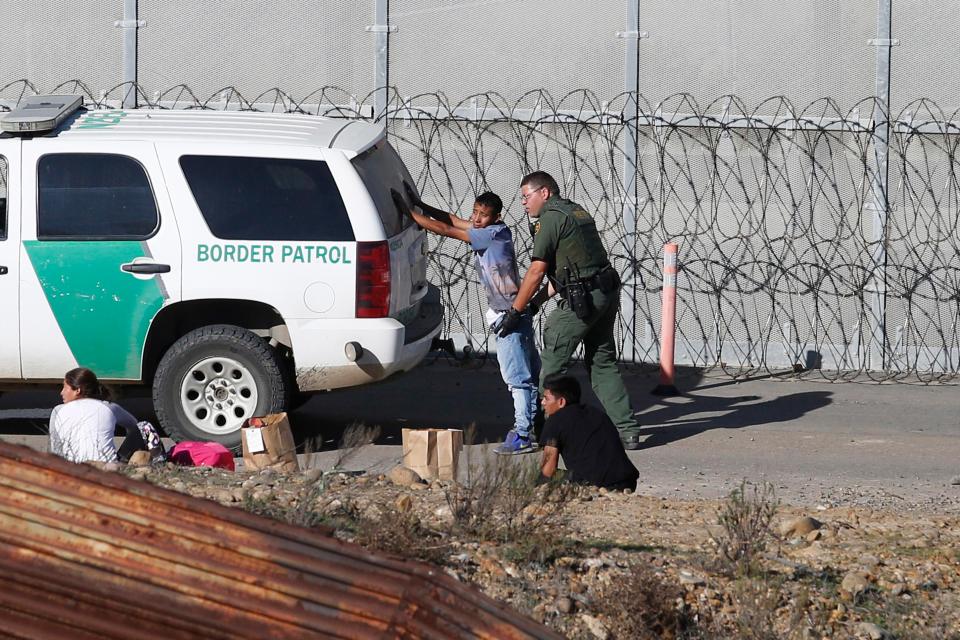  Honduran asylum seekers are taken into custody by US Border Patrol agents