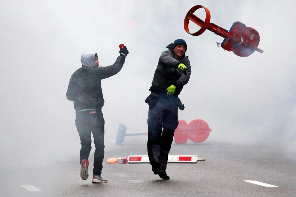  Protesters hurl missiles at cops during an anti-migration rally in Brussels