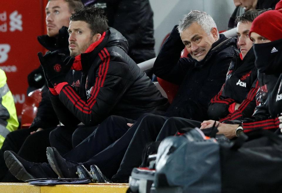 Mourinho winces as he watches United lose at Liverpool - his final game in charge