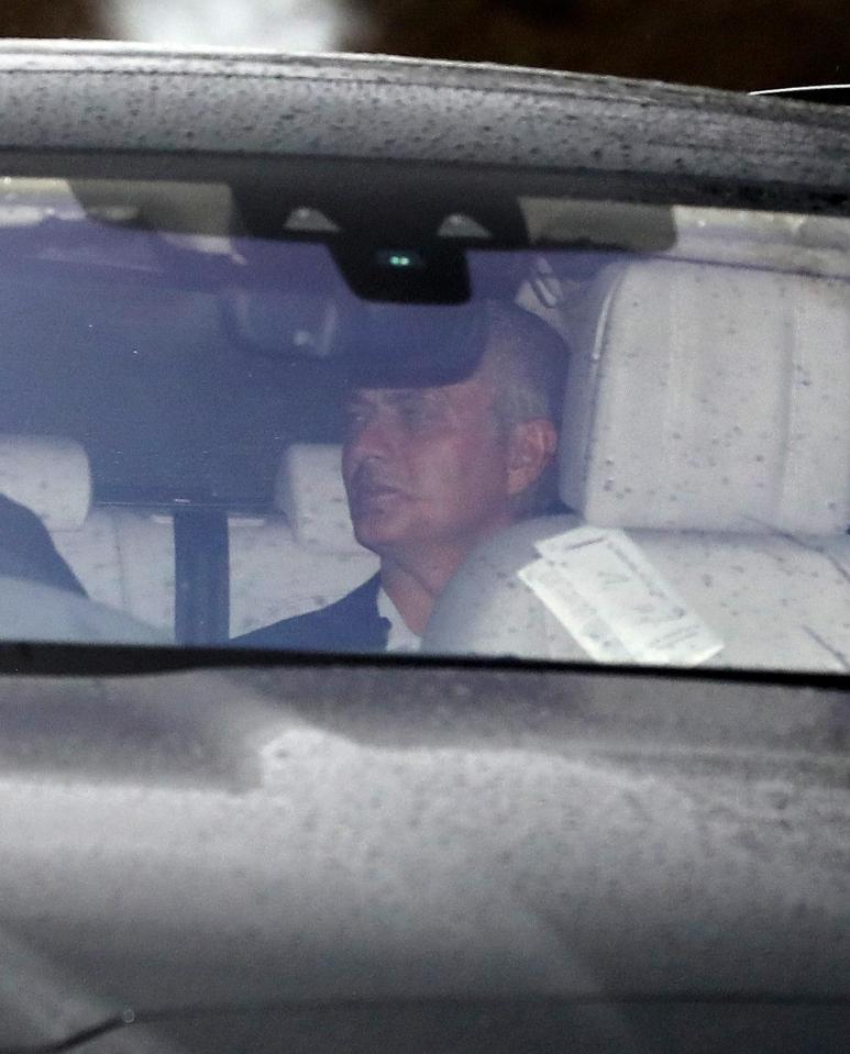 Mourinho grimaces as he is driven away from the training ground after his sacking