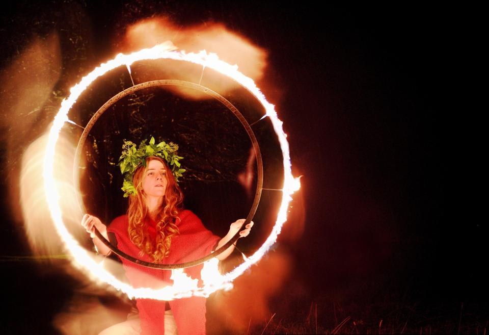  A young woman dances with fire to celebrate the winter solstice