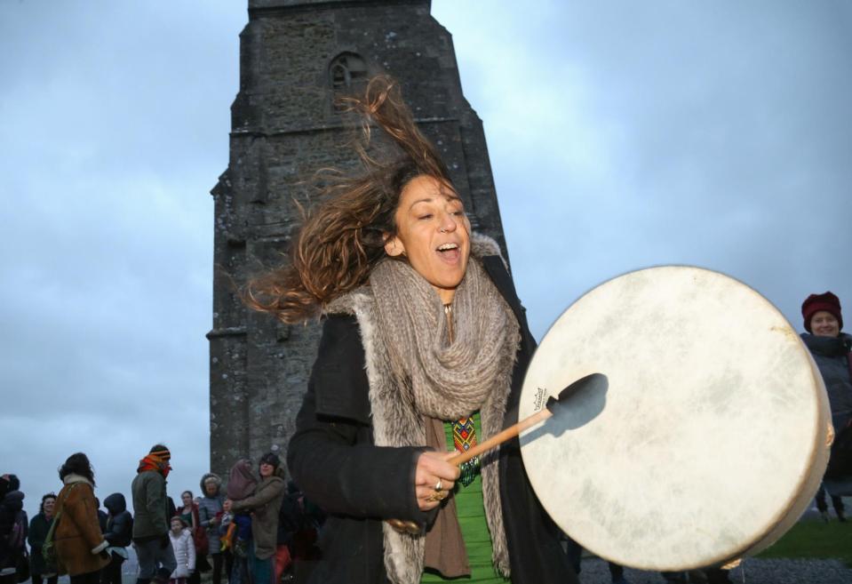  A woman celebrates the dawn on the year's shortest day