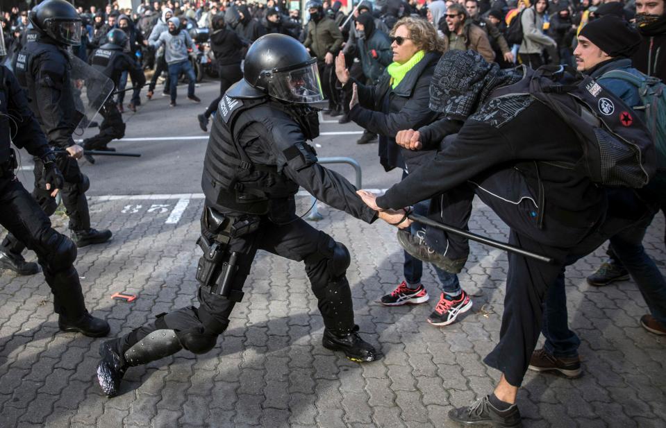  A protester being beaten by a police officer in