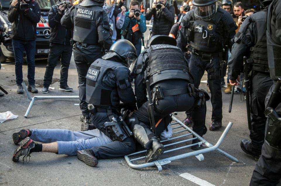  Protesters have clashed with riot-police on the streets of Barcelona